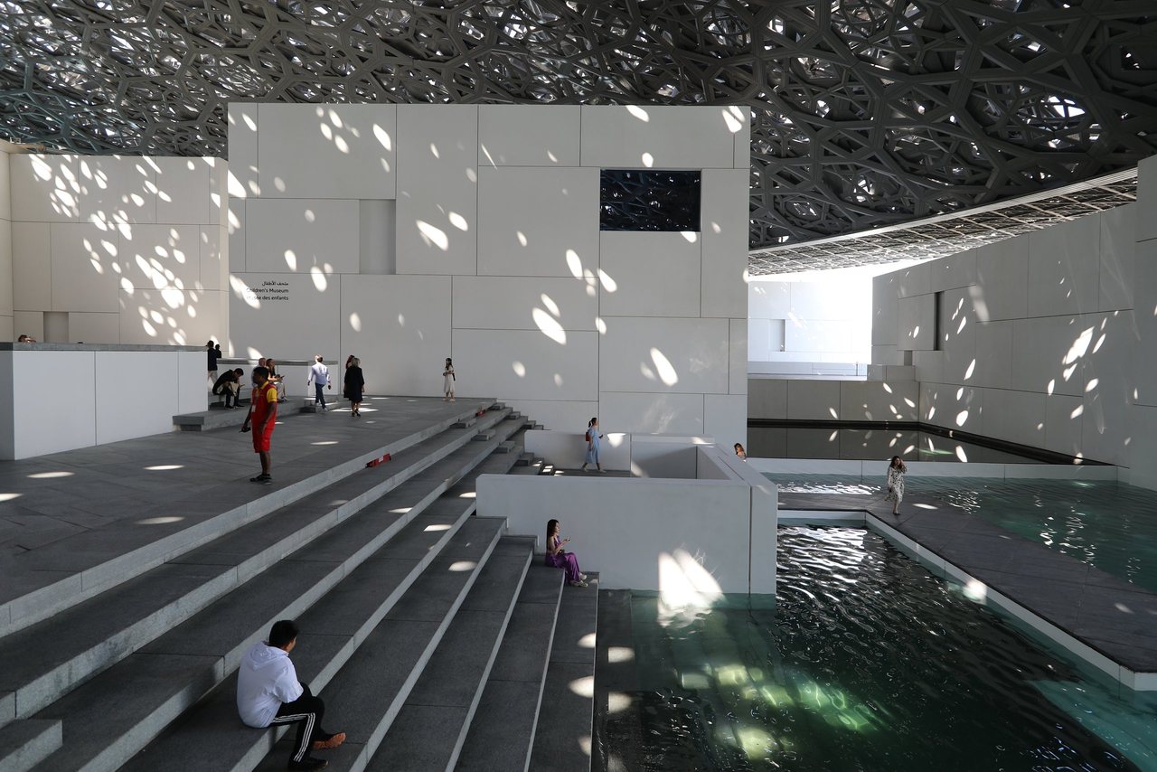 Light falling through the Louvre Abu Dhabi dome onto white stone